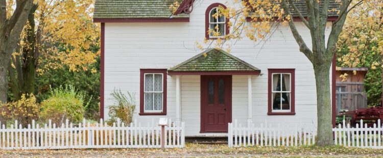 white house under maple trees